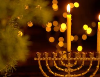 menorah with two candles and tree in background