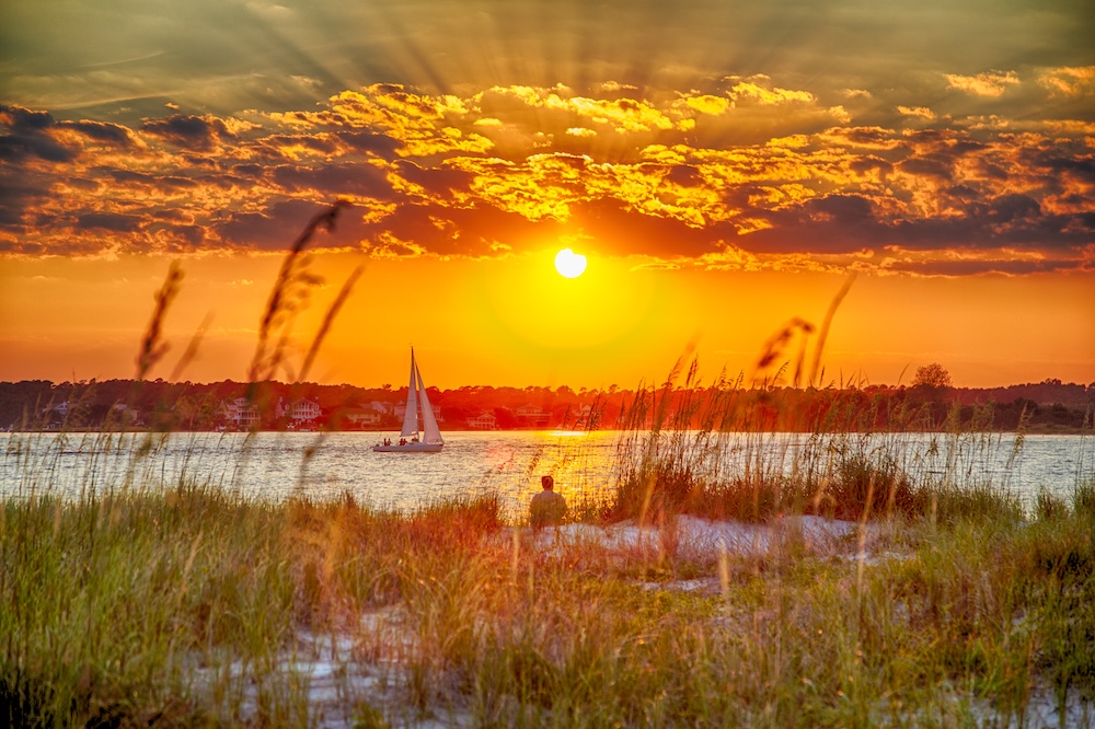 sailboat on water at sunset